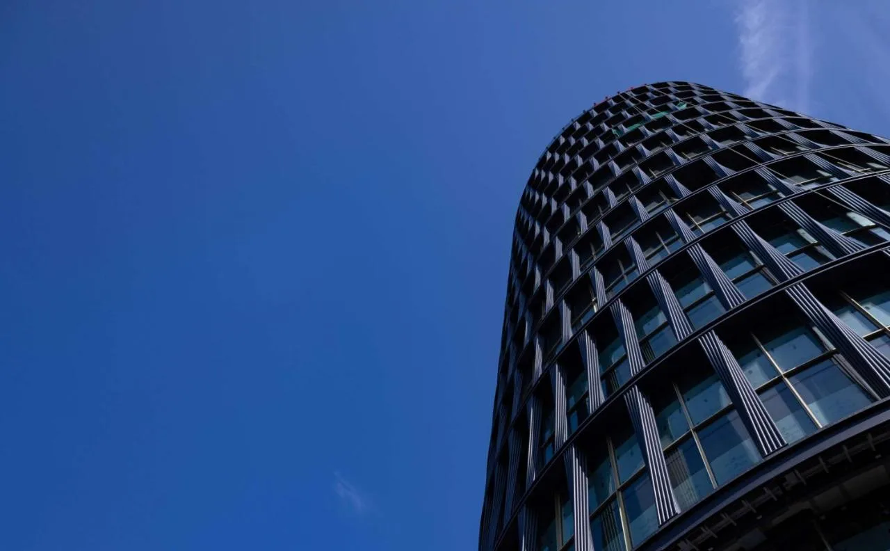 Tall art'otel London Hoxton building against a blue sky