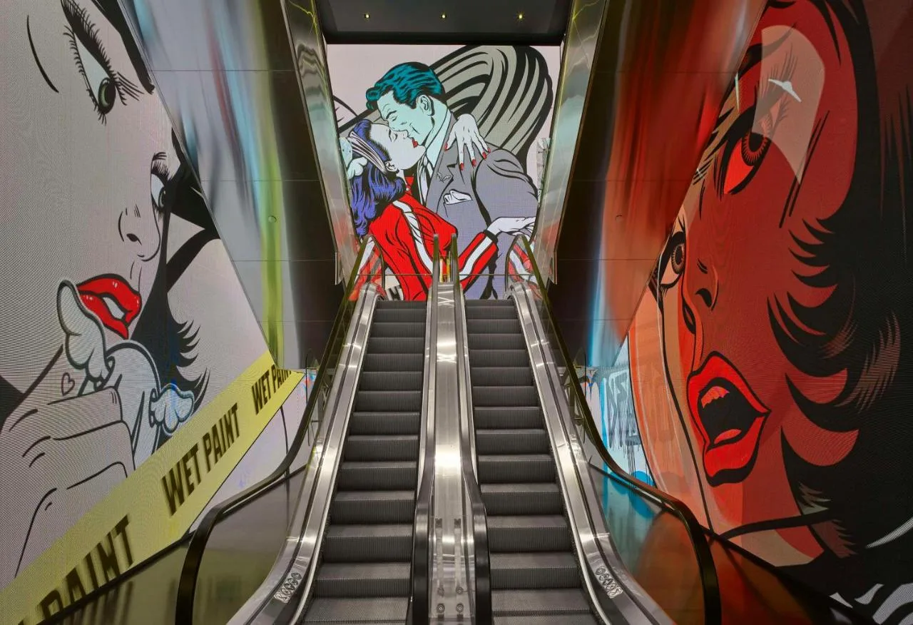 Escalator with anime-style artwork at art'otel London Hoxton